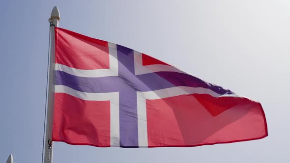 Flag of Norway Fluttering Against Blue Sky in Slow Motion
