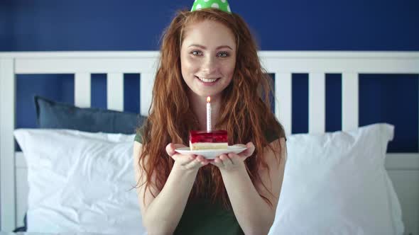 Portrait video of woman with a piece of birthday cake