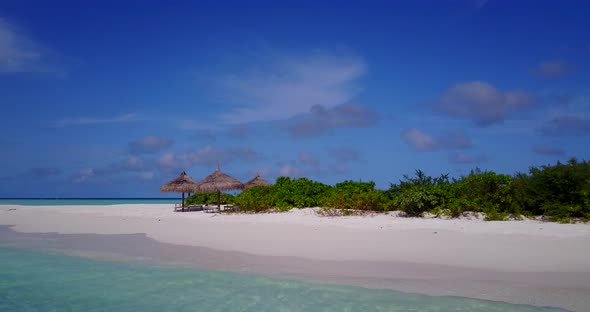 Wide angle overhead island view of a summer white paradise sand beach and blue water background in v