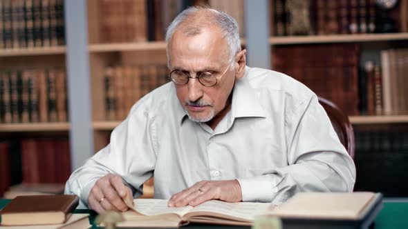 Elderly Man Professional Historic Professor Learning Antique Book Sitting Desk Workplace at Library