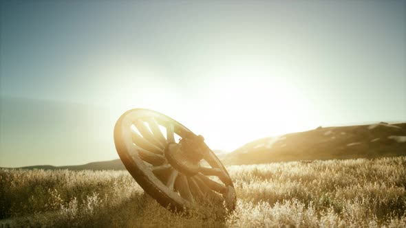 Old Wooden Wheel on the Hill at Sunset