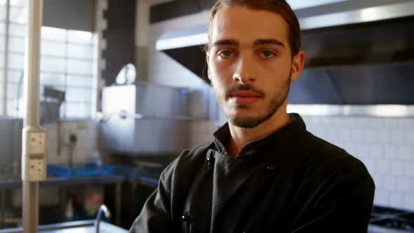 Confident chef standing in the commercial kitchen