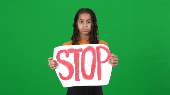 Frustrated Depressed African American Teenage Girl Showing Stop Message Banner Looking at Camera