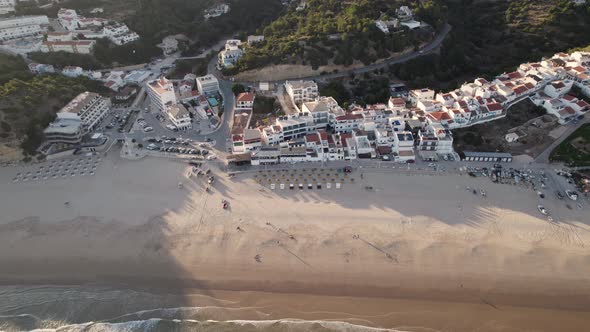 Flying over the picturesque Salema beach during golden hour. Aerial