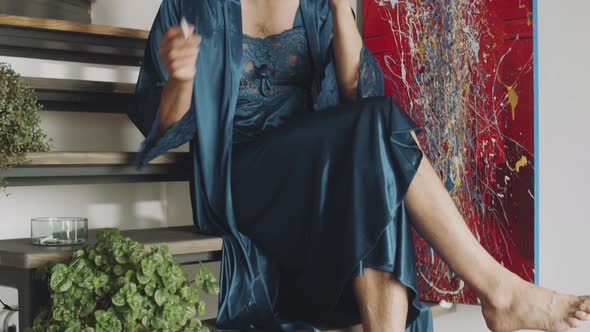 Transgender Man in Silk Robe Smoking and Having Drink at Home