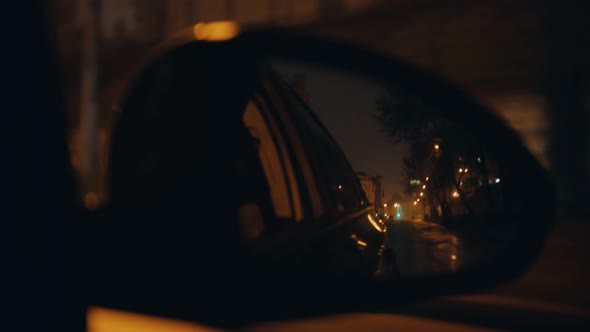 Side Mirror of an Automobile While Moving - Riding at Night