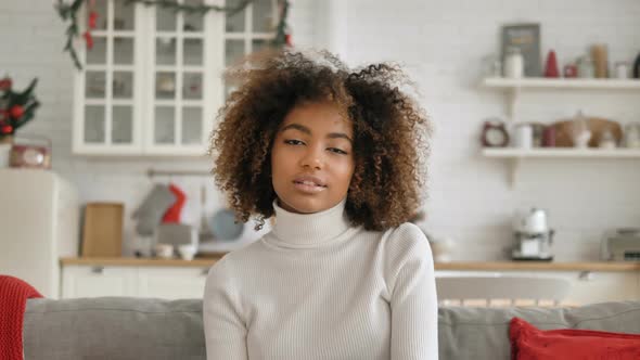 Calm Kinky Haired Young Woman Shows Cool Sign and Smiles