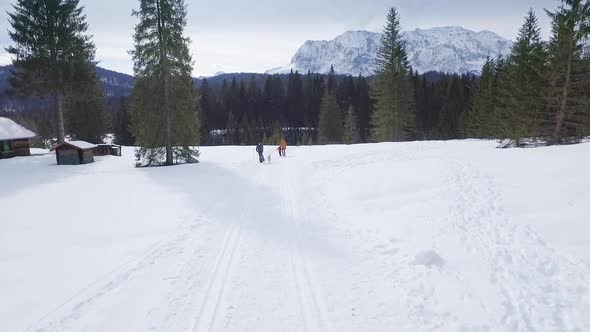 Happy family taking a winter walk with sibirian husky