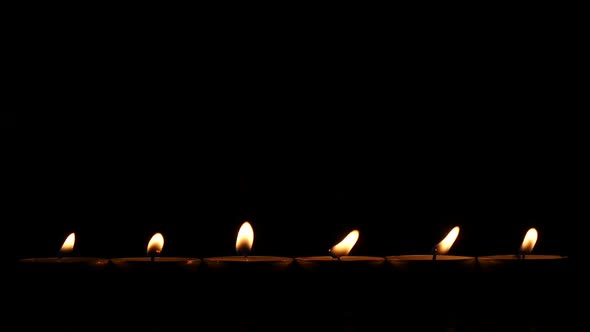 Six Small Candles in Dark. Close Up