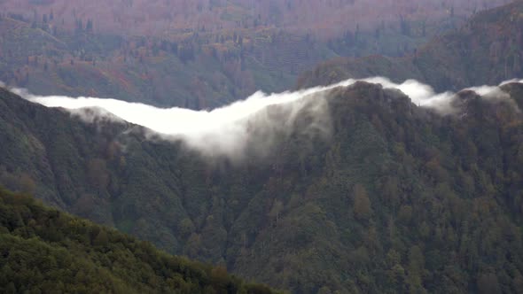 Cloud Eaterfall Flowing Down the Mountain Slope alt