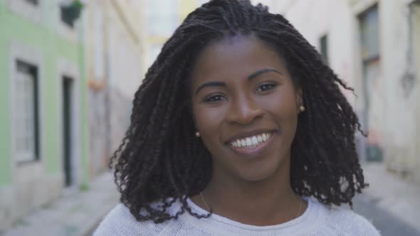 Happy African American Woman with Dreadlocks Looking at Camera