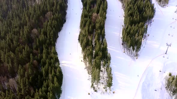 Drone flight over a group of people skiing in the ski resort during winter season alt