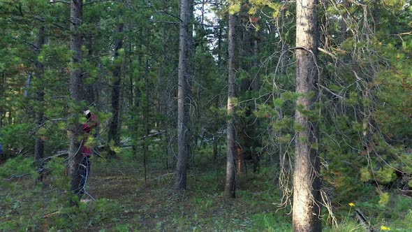 View of young women taking photos in thick forest