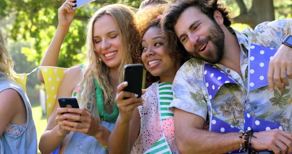 Hipster friends looking their mobile phone and tablet computer