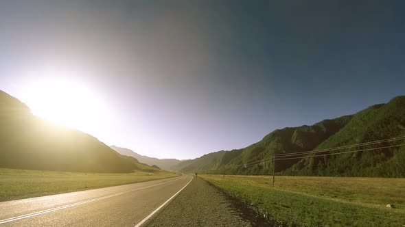 Mountain Road Timelapse at the Summer or Autumn Sunset Sunrise Time. Wild Nature and Rural Field.