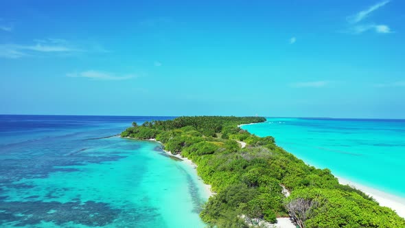 Wide angle above island view of a white sand paradise beach and blue water background in best qualit