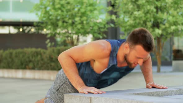 Young Man Doing Push Ups on City Street