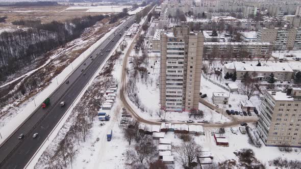 Suburban Highway with Multistorey Buildings and Cars in Winter Aerial View