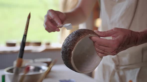 Woman Potter Finishing Handmade Ceramic Bowl