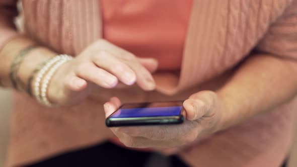 Grandmother In Glasses Scrolling On Screen On Cellphone. Old Granny Using Smartphone For Social.