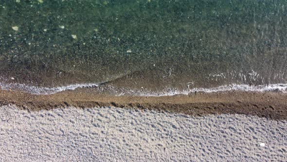 Aerial View From Above on Calm Azure Sea and Pebbles Beach