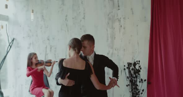 View of Tango to the Accompaniment of the Violin By Couple of Dancers