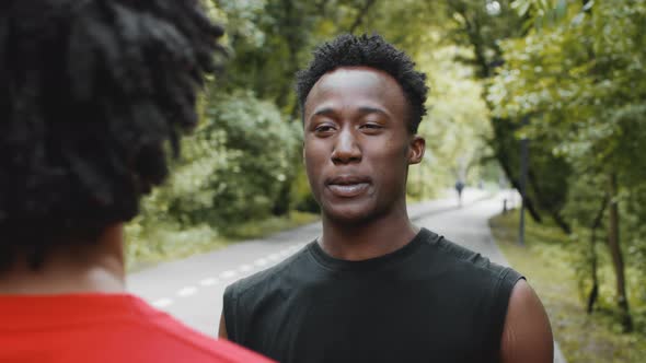 Two Young Black Guys Talking And Laughing Standing Outside