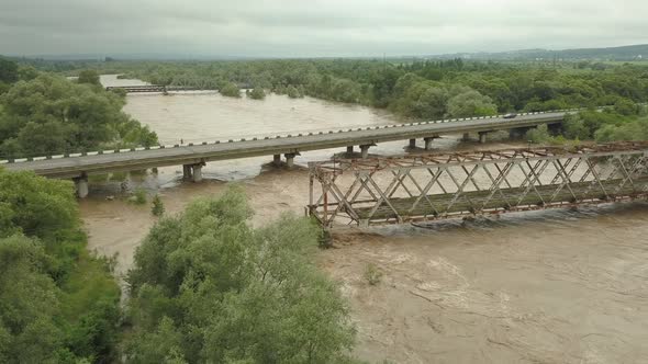 Aerial View of the Bridge During Floods. Extremely High Water Level in the River.