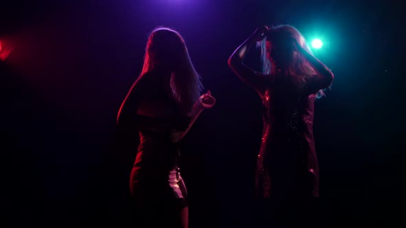 Silhouette of Dancing Girls with Long Hair in Disco Style