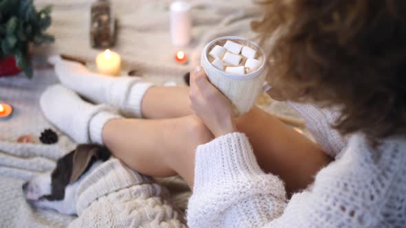 Cozy Winter Or Fall Season Concept. Woman Relaxing At Home In Knitted Socks