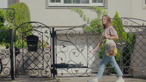 Woman walking with eco string bag