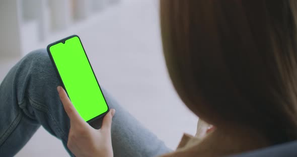 Young Girl Is Holding Smartphone With Green Screen At Evening Time. Smartphone in Hand, Static