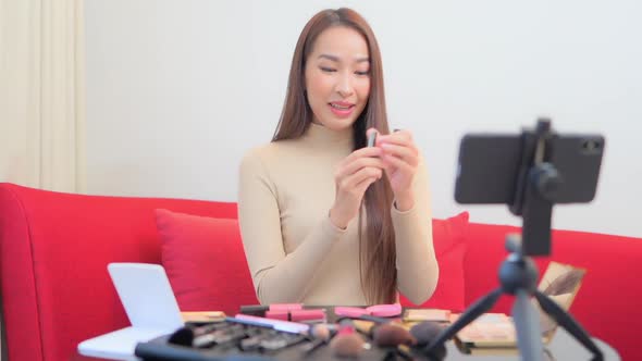 Young asian woman online review cosmetic