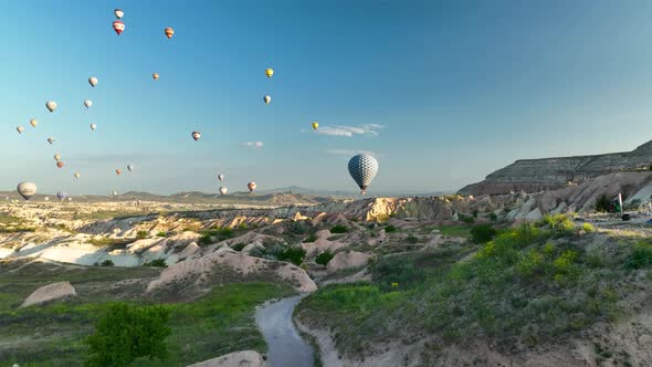 4K Aerial view of Goreme. Colorful hot air balloons fly over the valleys.