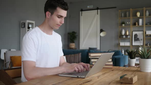 Excited Man Celebrating Success Working on Laptop