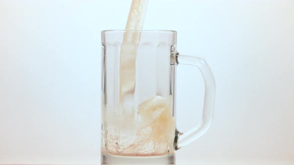 Beer being poured into a beer mug