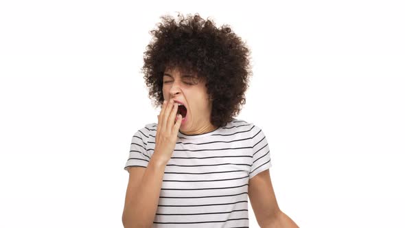 Close Up Portrait of Mixedrace Lady Being Sleepy Yawning and Stretching Covering Open Mouth with