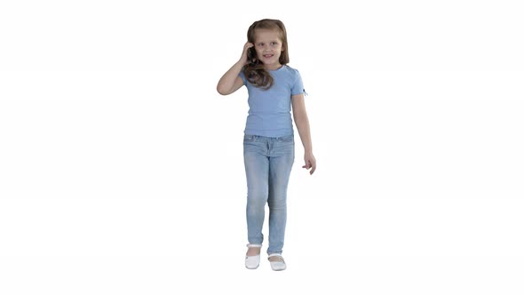 Little Cute Girl Making a Phone Call While Walking on White Background.