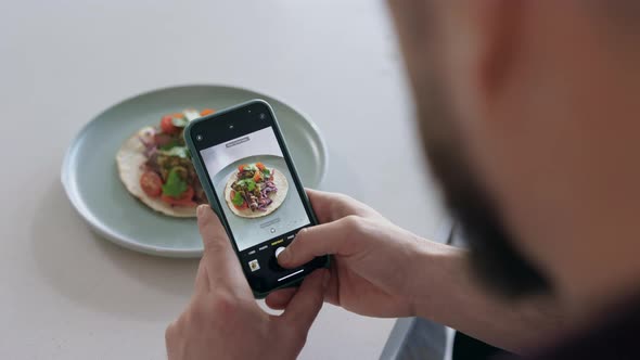Man Photographing Food with a Smartphone before Eating, Copy Space