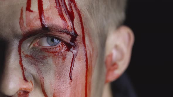 Halloween Man Portrait. Guy with Dripping Blood on His Face. Scary Makeup