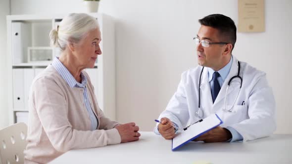 Senior Woman and Doctor with Cardiogram at Clinic