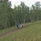 Young Parents with Children Hiking on a Forest Trail in the Mountains - VideoHive Item for Sale