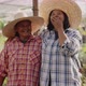 Happy Asian woman farmers looking to camera and laughing together on local organic vegetable farm. - VideoHive Item for Sale