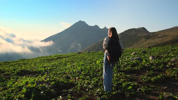 Explore Nature at Summer Vacation Young Female Backpacker is Strolling at Top of Mountain