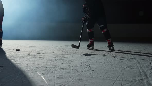 Two Men Hockey Player Masterfully Dribbles Hitting Puck with Stick and Forward Scores Goal