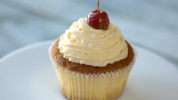 Cupcake with Vanilla Topping on Plate