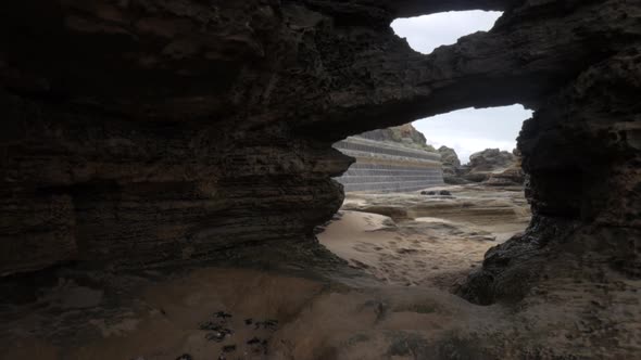 Walk though of eroded rock formations on an Australian beach. Wide angle shot on a gimbal.