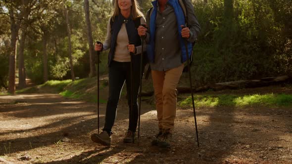 Active senior couple hiking in forest