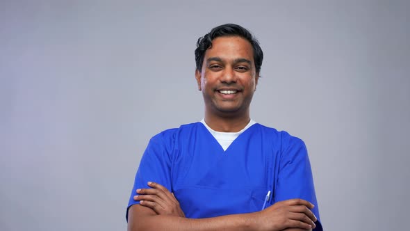 Happy Indian Doctor or Male Nurse in Blue Uniform