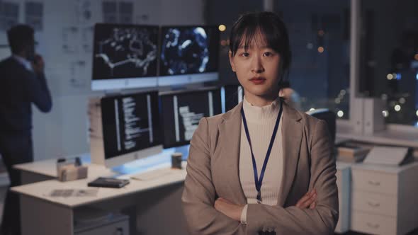 Asian Woman Posing in Dark IT Office